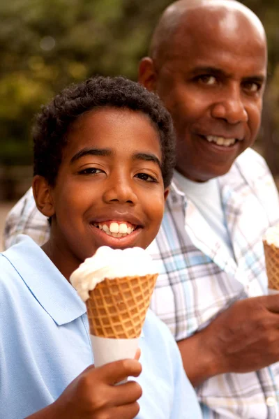 Father and son eating ice cream.
