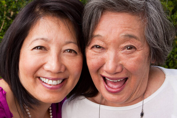 Mature Asian mother and her adult daughter.