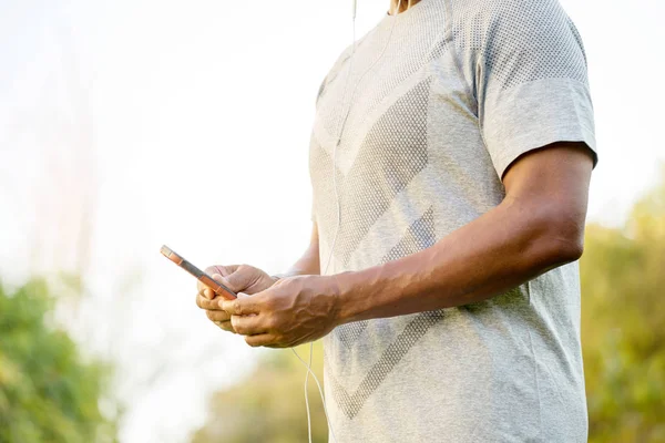 Fit African American man listening to music. — Stock Photo, Image