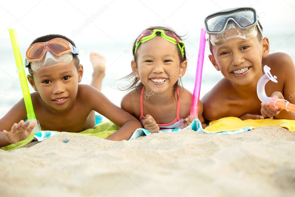 Asian kids playing on the beach.