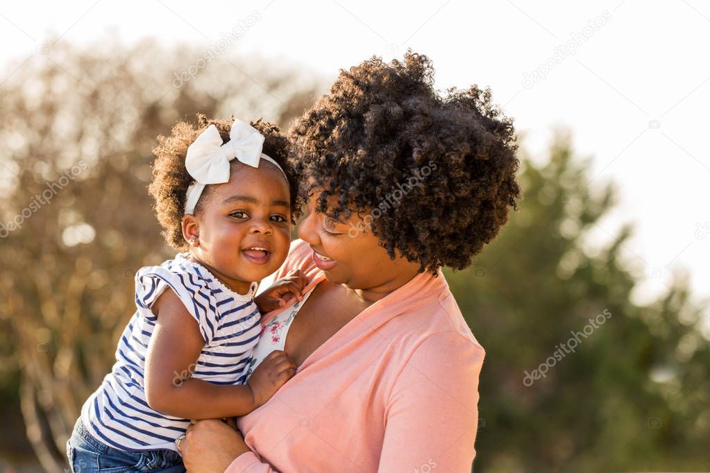 African American mother holding her daughter.