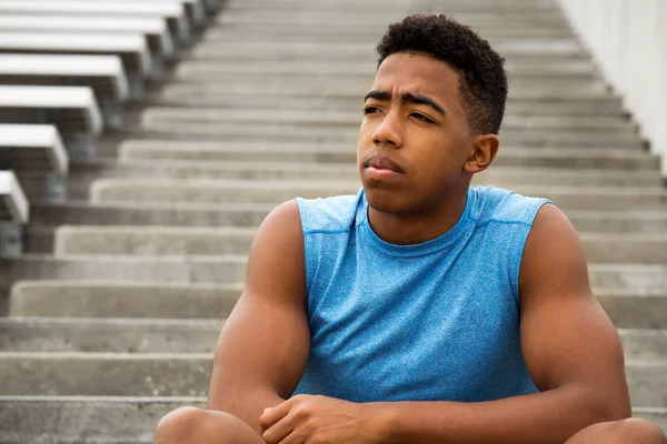 Young African Amerian teenage athlete thinking about his future. — Stock Photo, Image