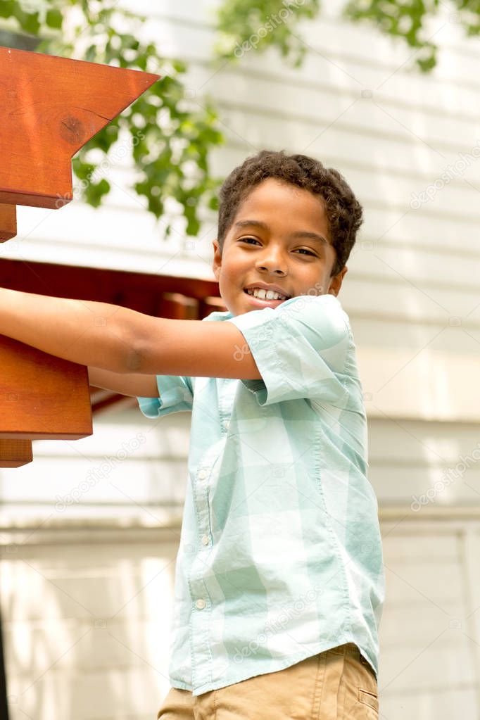 Young mixed race little boy playing and smiling.