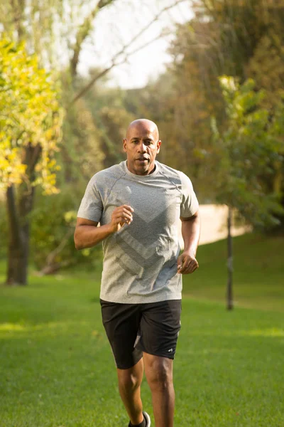 Mature fit African American man running outside. — Stock Photo, Image