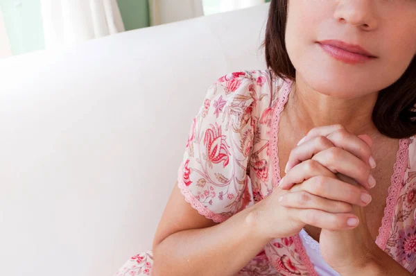 Multicultural woman in deep thought thinking and praying.