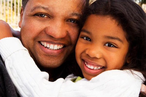 Biracial father and daughter laughing and smiling outside. — Stock Photo, Image