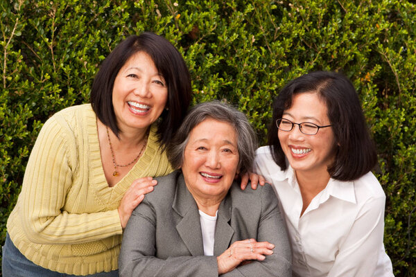 Mature Asian mother and her adult daughters.