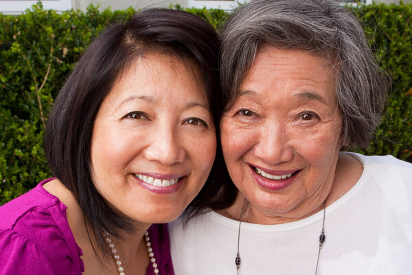 Mature Asian mother and her adult daughter.