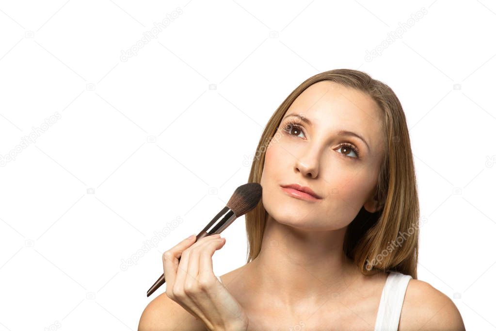 Confident woman applying makeup isolated on white.