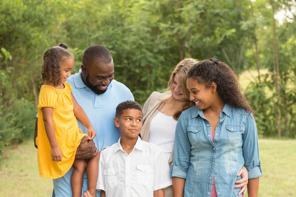 Portrait of a multi ethnic family laughing. — Stock Photo, Image