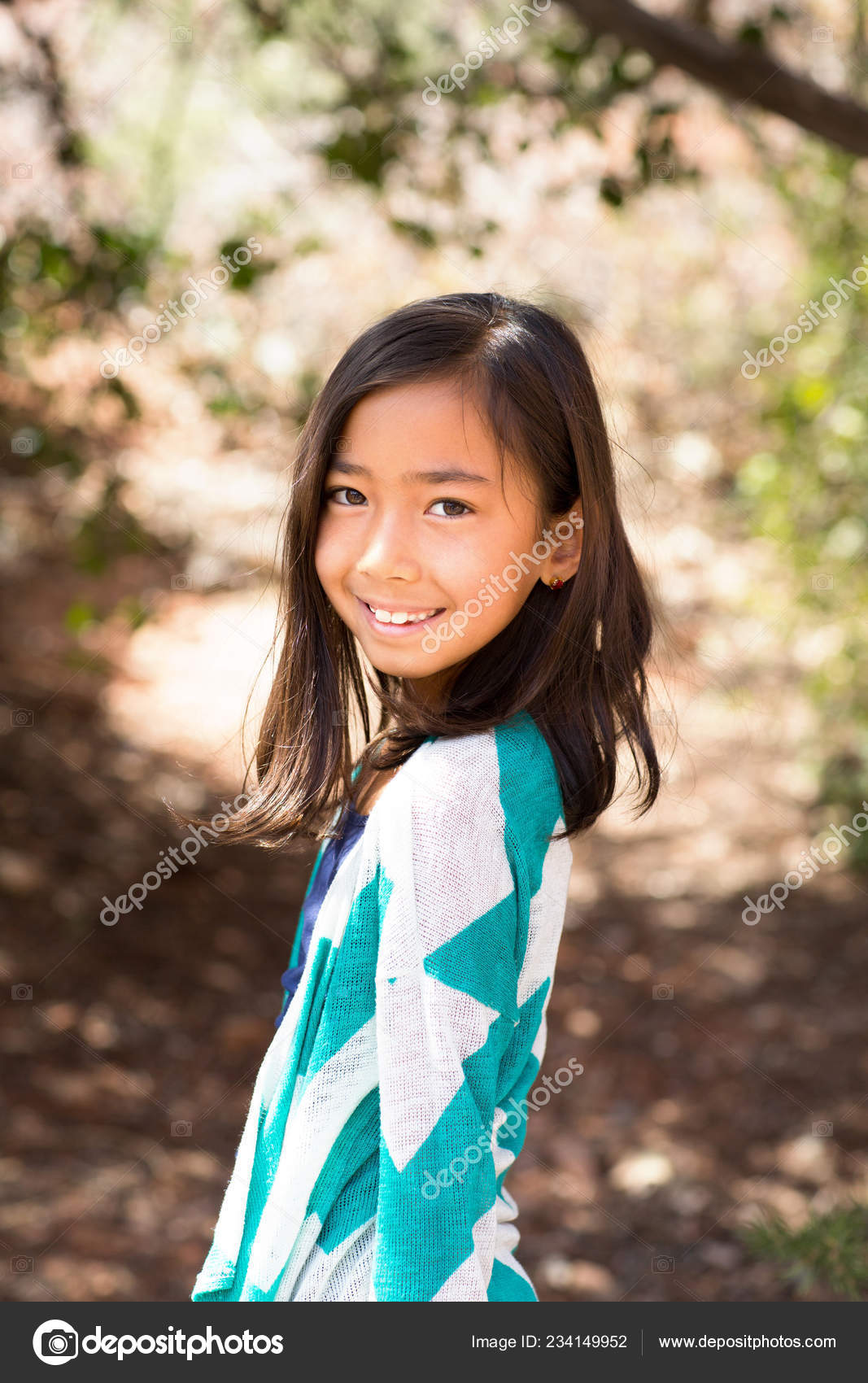 Portrait of a young asian girl smiling outside. Stock Photo by  ©pixelheadphoto 234149952