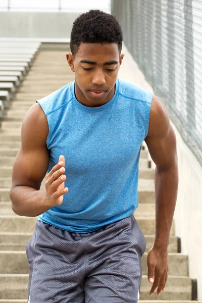 African American Teenage athlete running the bleachers — Stock Photo, Image