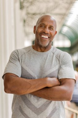 Happy mature African American man smiling outside. clipart