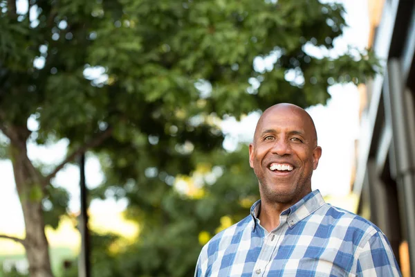 Happy mature African American man smiling outside. — Stock Photo, Image