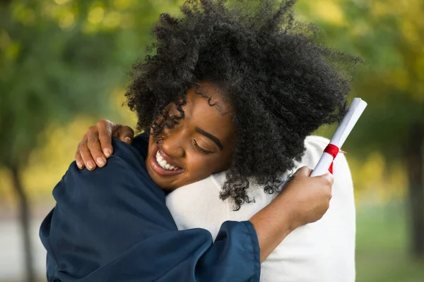 Madre e sua figlia si abbracciano alla sua laurea . — Foto Stock