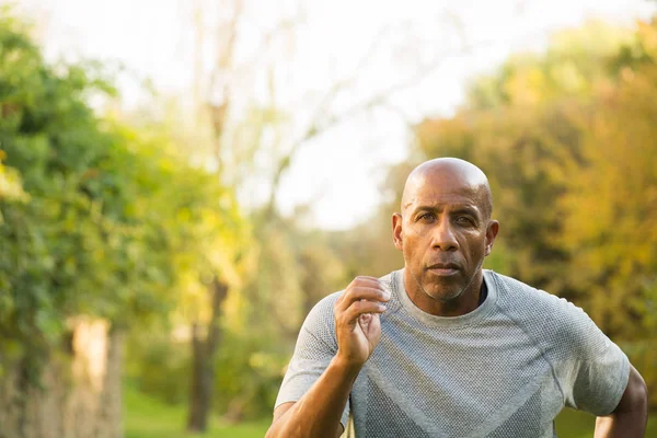 Mature fit African American man running outside. — Stock Photo, Image