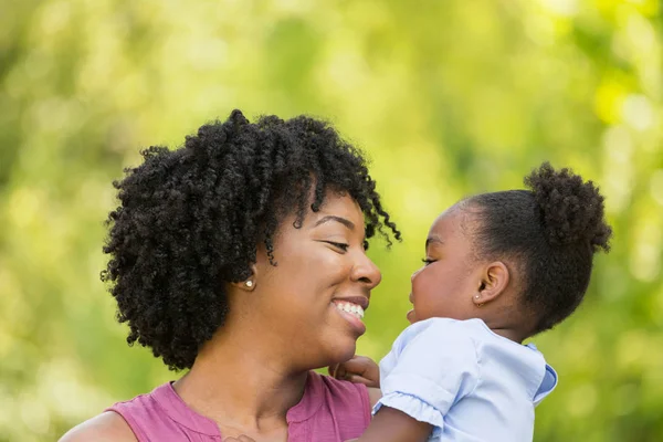 African American mother laughing and hugging her daughter. — Stock Photo, Image