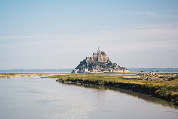 Mont Saint Michel view from the water in Normandy, France.