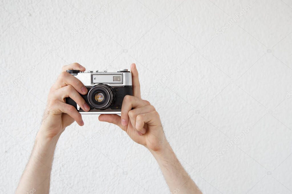 a man's hand with an old camera