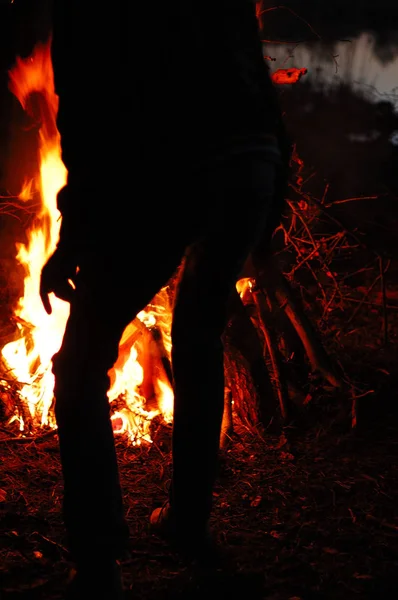 A large bonfire in the dark at night in the forest.