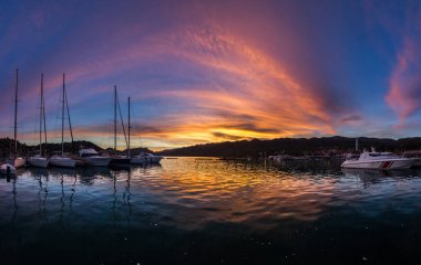 panorama of colorful sunset on mediterranean sea with yachts clipart