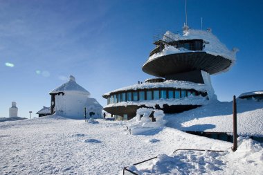 CZECH REPUBLIC; SNEZKA - JAN 11, 2016: Polish chalet on Snezka peak. Snowy winter countryside, Snezka mount - Ruzova hora, Krkonose (Giant mountains), Czech republic clipart