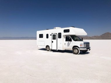 Motorhome (RV)  on Bonneville Salt Flats in Utah near the Utah-Nevada border. clipart