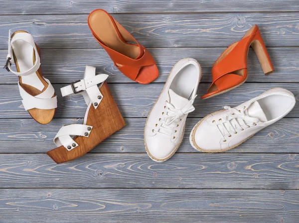 Набор женской обуви (плоские сандалии) на деревянном фоне. Весна — стоковое фото