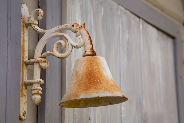 Rusty, vintage door bell on the wall