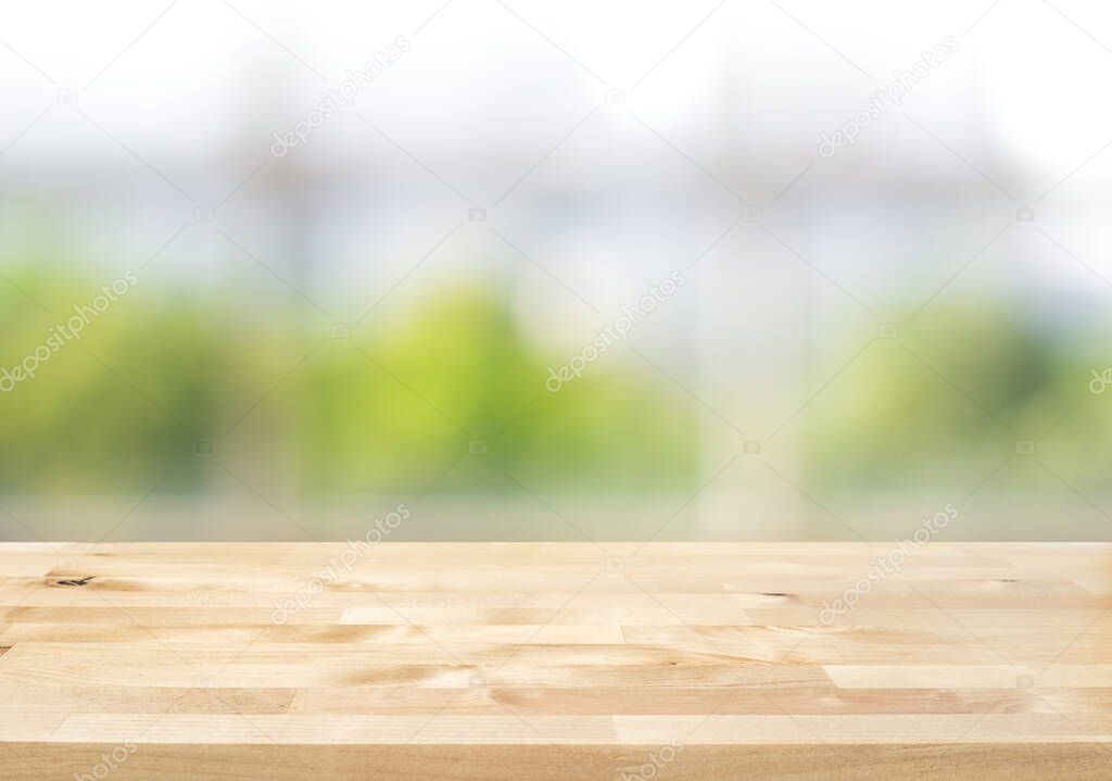 Empty wood table top on blur abstract green garden from window kitchen in the morning.For montage product display or design key visual layout