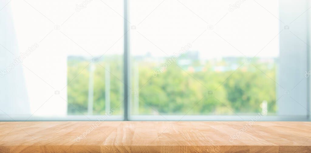 Empty wood table with blur  window view background.For montage product display or design key visual layout.