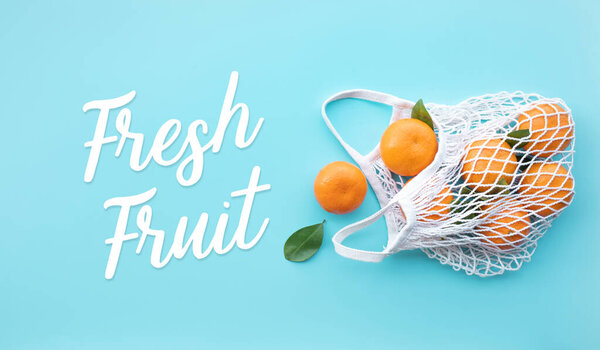 Fresh fruit text with orange from garden in crochet bag.healthy and nature concepts.top view