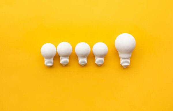 Business creativity and leadership concepts with lightbulb on yellow background.motivation for success.think big ideas