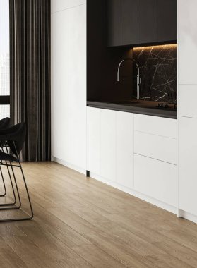 Bu çağdaş mutfak, minimalist eşyalar ve sıcak ahşap döşemeleri davet eden zarif bir tasarım sergiliyor.