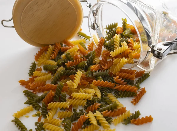 Vegetable pasta spirals on a white background and fun effects, colorful and ideal for espot.