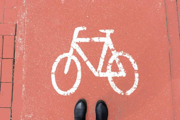 stock image Pedestrian shoes on the coral-colored walkway for cyclists