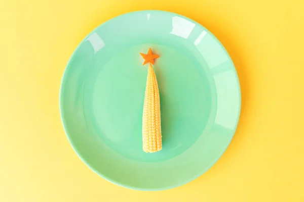 Funny edible Christmas tree from baby corn and carrot.