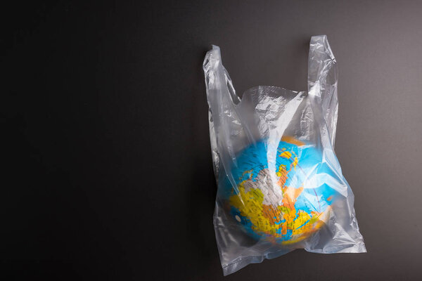 Plastic bag Earth world globe isolated on black background. Savi