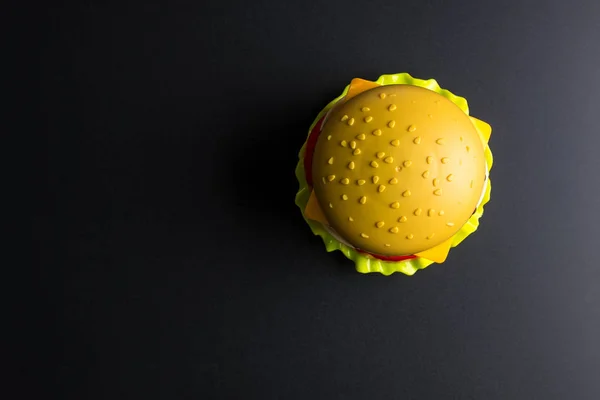 Plastic burger Fast food on black background. Children\'s toy. Co