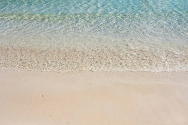 Kumsal ve deniz arka planı, kum ve baloncuk, dalga. Kumlu sahilde yumuşak bir dalga. Arkaplan.