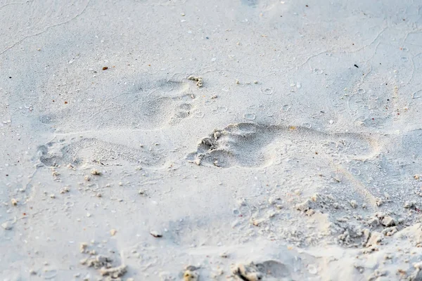 Foot print on sand at beach.Thailand.