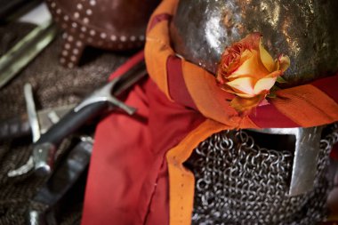 Rose flower on the helmet of a medieval warrior clipart