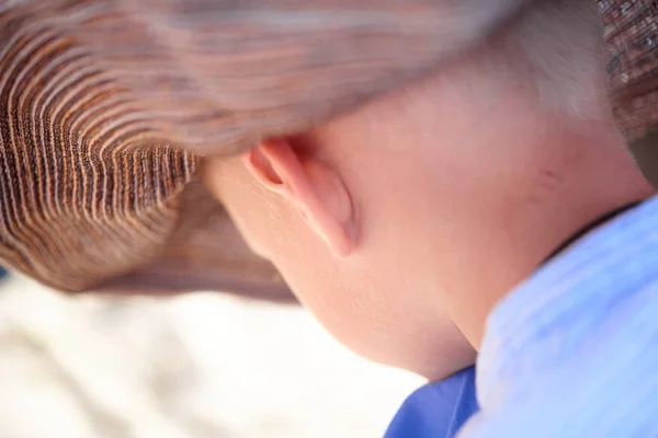 母の帽子で悲しい子供少年はビーチで退屈しています — ストック写真