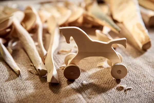Caballo figurado de juguete tallado en madera, carpintero en el taller — Foto de Stock
