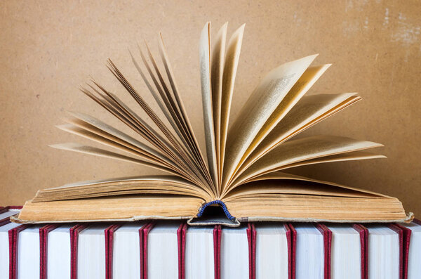 Open book in hardcover. Back to school. Wooden background