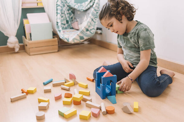 little girl playing with building blocks