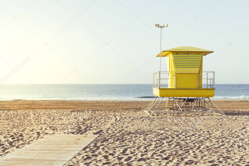 Yellow lifeguard house on the beach