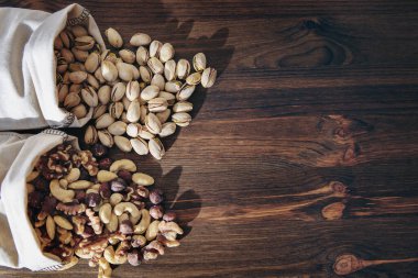 Ahşap arka planda fındık ve kuru meyveleri karıştır