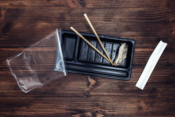 Top View Plastic Tray Precooked Asiatic Food Chopsticks Dark Wooden — Stock Photo, Image