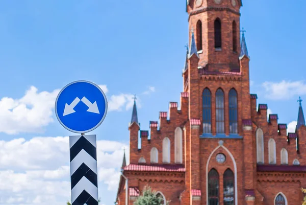 Roman Catholic Church on bright summer day with road sign on foregroung. Neo-gothic Architecture style. Stock photo